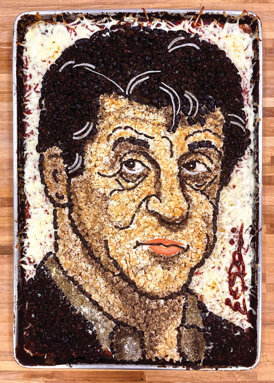PIZZA ART: Eric Palmieri crafts portraits with pizza. He’s tackled an array of subjects from action star Sylvester Stallone to late Fall River murderess Lizzie Borden, to pizza reviewer and Barstool Sports magnate Dave Portnoy. (Submitted photo)